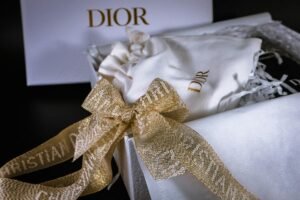 Luxurious Dior gift box featuring a golden sequin ribbon, exuding elegance and style.